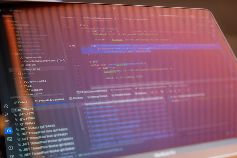 Focused view of a computer screen displaying programming code with visible reflections